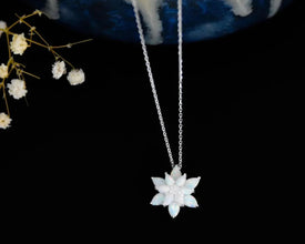 A dainty and delicate lotus flower pendant, perfect for spiritual and wellness seekers.