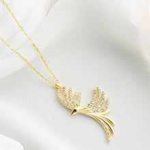 Gold necklace with a bird-shaped pendant on a white cushion