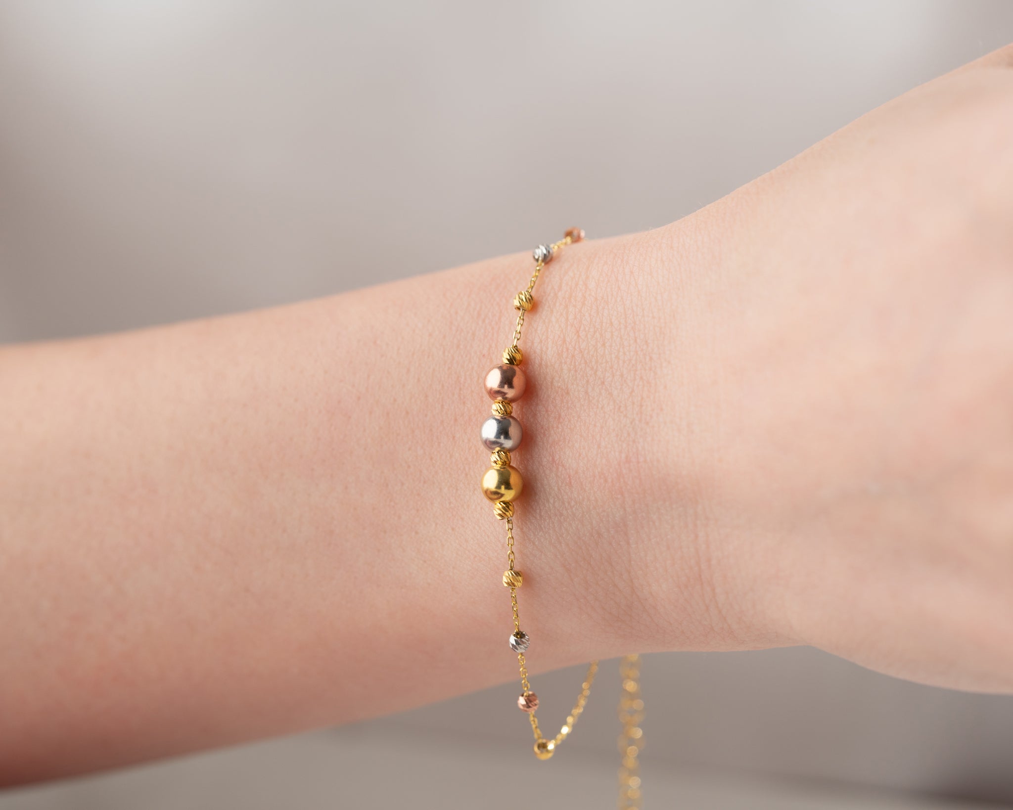 Dainty handmade bracelet featuring a combination of three metal tones for a refined look.