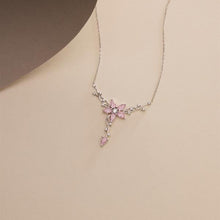 Necklace with a pink floral pendant on a beige background
