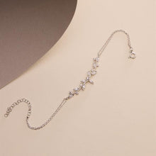 Silver bracelet with floral design on a beige background