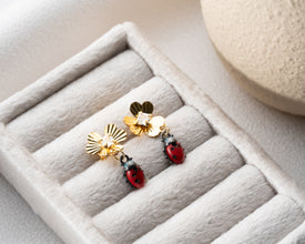 Close-up of handcrafted silver ladybug earrings with polished finish