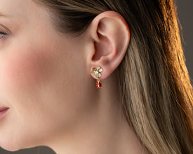 Size comparison: ladybug earrings shown next to a quarter for scale