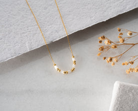 Necklace displayed on modern jewelry stand