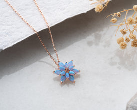 Minimalist lotus flower necklace with a delicate light blue opal charm